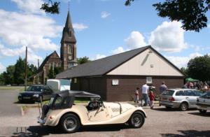 The village hall with St James church behind